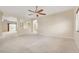 Spacious living room featuring neutral carpet, ceiling fan, and an open floor plan with lots of light at 6402 Parrot Ridge Ct, Las Vegas, NV 89139