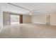 Spacious living room featuring wood-look ceramic tile flooring, recessed lighting, and a ceiling fan at 6402 Parrot Ridge Ct, Las Vegas, NV 89139