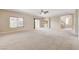 Spacious living room with neutral carpet, recessed lighting, and sliding glass doors leading to the outside balcony at 6402 Parrot Ridge Ct, Las Vegas, NV 89139