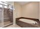 Main bathroom showcasing a soaking tub and a glass-enclosed shower at 6402 Parrot Ridge Ct, Las Vegas, NV 89139