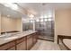 Large main bathroom featuring dual sinks, walk-in shower, and a soaking tub at 6402 Parrot Ridge Ct, Las Vegas, NV 89139