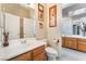 Bathroom vanity with a white sink, wood cabinets, and framed art on the wall at 7076 Oakleigh Dr, Las Vegas, NV 89110