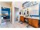 Bathroom featuring a double vanity, soaking tub, and separate glass-enclosed shower at 7076 Oakleigh Dr, Las Vegas, NV 89110