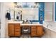 Bathroom featuring a double vanity, soaking tub, and separate glass-enclosed shower at 7076 Oakleigh Dr, Las Vegas, NV 89110