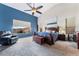 Primary bedroom with a large window, ceiling fan, and blue accent wall at 7076 Oakleigh Dr, Las Vegas, NV 89110