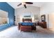 Primary bedroom with a large window, ceiling fan, and blue accent wall at 7076 Oakleigh Dr, Las Vegas, NV 89110