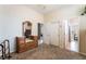 Bedroom with a large wooden dresser, closet, and views into the hall and other rooms at 7076 Oakleigh Dr, Las Vegas, NV 89110
