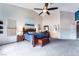 Primary bedroom with a large window, ceiling fan, and blue accent wall at 7076 Oakleigh Dr, Las Vegas, NV 89110