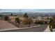 Street view with houses and a clear view of the Las Vegas skyline at 7076 Oakleigh Dr, Las Vegas, NV 89110