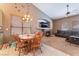 Charming dining area with a wooden table, elegant lighting fixture, and cozy fireplace at 7076 Oakleigh Dr, Las Vegas, NV 89110