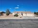 Charming single-story home with a three-car garage and desert landscaping on a sunny day at 7076 Oakleigh Dr, Las Vegas, NV 89110