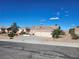 Inviting single-story home with a three-car garage surrounded by lush desert landscaping at 7076 Oakleigh Dr, Las Vegas, NV 89110