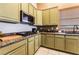 Well-equipped kitchen featuring granite countertops, stainless steel appliances, and updated cabinetry at 7076 Oakleigh Dr, Las Vegas, NV 89110