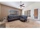 Inviting living room featuring a comfortable sectional sofa, ceiling fan, and neutral color palette at 7076 Oakleigh Dr, Las Vegas, NV 89110