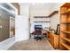 Bright and spacious office space with a desk, chair, shelves, and carpeted floor at 7076 Oakleigh Dr, Las Vegas, NV 89110