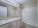 Well-lit bathroom with updated vanity, shower, and tub is designed for relaxation and convenience at 713 Wheat Ridge Ln # 102, Las Vegas, NV 89145