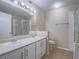 Bright bathroom featuring a double sink vanity and a glass-enclosed shower at 713 Wheat Ridge Ln # 102, Las Vegas, NV 89145