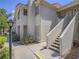 Light stucco exterior featuring stairs to the second level and desert landscaping at 713 Wheat Ridge Ln # 102, Las Vegas, NV 89145