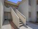 Stucco exterior featuring stairs to the second level at 713 Wheat Ridge Ln # 102, Las Vegas, NV 89145