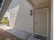 Unit 102 has a white metal security door and stone landscaping at 713 Wheat Ridge Ln # 102, Las Vegas, NV 89145