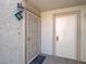 View of the white metal security door and the white entry door to unit 102 at 713 Wheat Ridge Ln # 102, Las Vegas, NV 89145