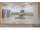 Bright kitchen featuring granite countertops, a stainless steel refrigerator, and a convenient gas range at 713 Wheat Ridge Ln # 102, Las Vegas, NV 89145