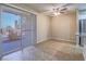 Open floor plan with tile flooring, sliding glass doors to a patio, and a ceiling fan at 713 Wheat Ridge Ln # 102, Las Vegas, NV 89145