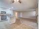 Inviting living room with tile flooring, a ceiling fan, and a kitchen island for seamless entertaining at 713 Wheat Ridge Ln # 102, Las Vegas, NV 89145