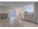 Open-concept living room with fireplace, tile floors and an adjacent kitchen with a bar at 713 Wheat Ridge Ln # 102, Las Vegas, NV 89145