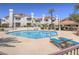 Sparkling community pool surrounded by lounge chairs and shade cabana, a perfect summer escape at 713 Wheat Ridge Ln # 102, Las Vegas, NV 89145