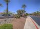 Welcoming Elan community entrance with lush landscaping and mature trees offers a serene environment at 713 Wheat Ridge Ln # 102, Las Vegas, NV 89145