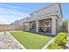Spacious backyard featuring artificial turf, a covered patio, and low-maintenance landscaping at 7456 Tinley Creek Ave, Las Vegas, NV 89113