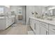 Bright bathroom featuring double sinks, sleek vanity, and glass-enclosed shower at 7456 Tinley Creek Ave, Las Vegas, NV 89113