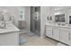 This bathroom features double sinks, sleek vanity, and glass-enclosed shower at 7456 Tinley Creek Ave, Las Vegas, NV 89113