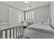 Cozy bedroom offers ample light from the window with a baby crib at 7456 Tinley Creek Ave, Las Vegas, NV 89113