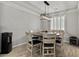 Dining room features a modern chandelier and plantation shutters for natural light at 7456 Tinley Creek Ave, Las Vegas, NV 89113