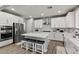 Bright kitchen with white cabinets, stainless steel appliances, and a center island with seating at 7456 Tinley Creek Ave, Las Vegas, NV 89113