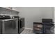 Modern laundry room with side-by-side washer and dryer at 7456 Tinley Creek Ave, Las Vegas, NV 89113