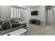 Comfortable living room with gray sectional sofa, large TV, and media cabinet at 7456 Tinley Creek Ave, Las Vegas, NV 89113