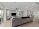 Bright, open-concept living room featuring a plush sectional sofa, modern ceiling fan, and wall-mounted television at 7456 Tinley Creek Ave, Las Vegas, NV 89113