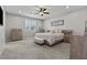 Bright main bedroom boasts neutral decor, ceiling fan, and light wood furnishings at 7456 Tinley Creek Ave, Las Vegas, NV 89113