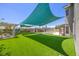 Expansive backyard showcasing artificial grass, a pergola, and a fenced pool area at 747 Canyon Crest Dr, Las Vegas, NV 89123