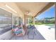 Relaxing outdoor patio with stylish seating, overlooking the pool and lush backyard, ideal for leisure at 747 Canyon Crest Dr, Las Vegas, NV 89123