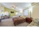 Carpeted bedroom with multiple beds, a ceiling fan, and plenty of natural light from the windows at 747 Canyon Crest Dr, Las Vegas, NV 89123