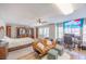 Bright bedroom featuring hard wood floors, large windows, ceiling fan, and a futon at 747 Canyon Crest Dr, Las Vegas, NV 89123
