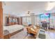 Bright bedroom featuring hard wood floors, large windows, ceiling fan, and a futon at 747 Canyon Crest Dr, Las Vegas, NV 89123