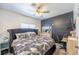 Serene bedroom showcasing a stylish bed, modern dresser, and elegant ceiling fan for added comfort at 747 Canyon Crest Dr, Las Vegas, NV 89123