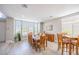 Dining room with wood-look floors, large table and chairs, and a view into an adjacent living area at 747 Canyon Crest Dr, Las Vegas, NV 89123