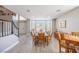 Dining room with a large table, wood-look flooring, natural lighting, and staircase access at 747 Canyon Crest Dr, Las Vegas, NV 89123