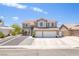 Charming two-story home with a three-car garage, tile roof, and well-maintained landscaping on a sunny day at 747 Canyon Crest Dr, Las Vegas, NV 89123